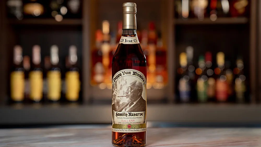 A bottle of Pappy Van Winkle bourbon on a wooden table